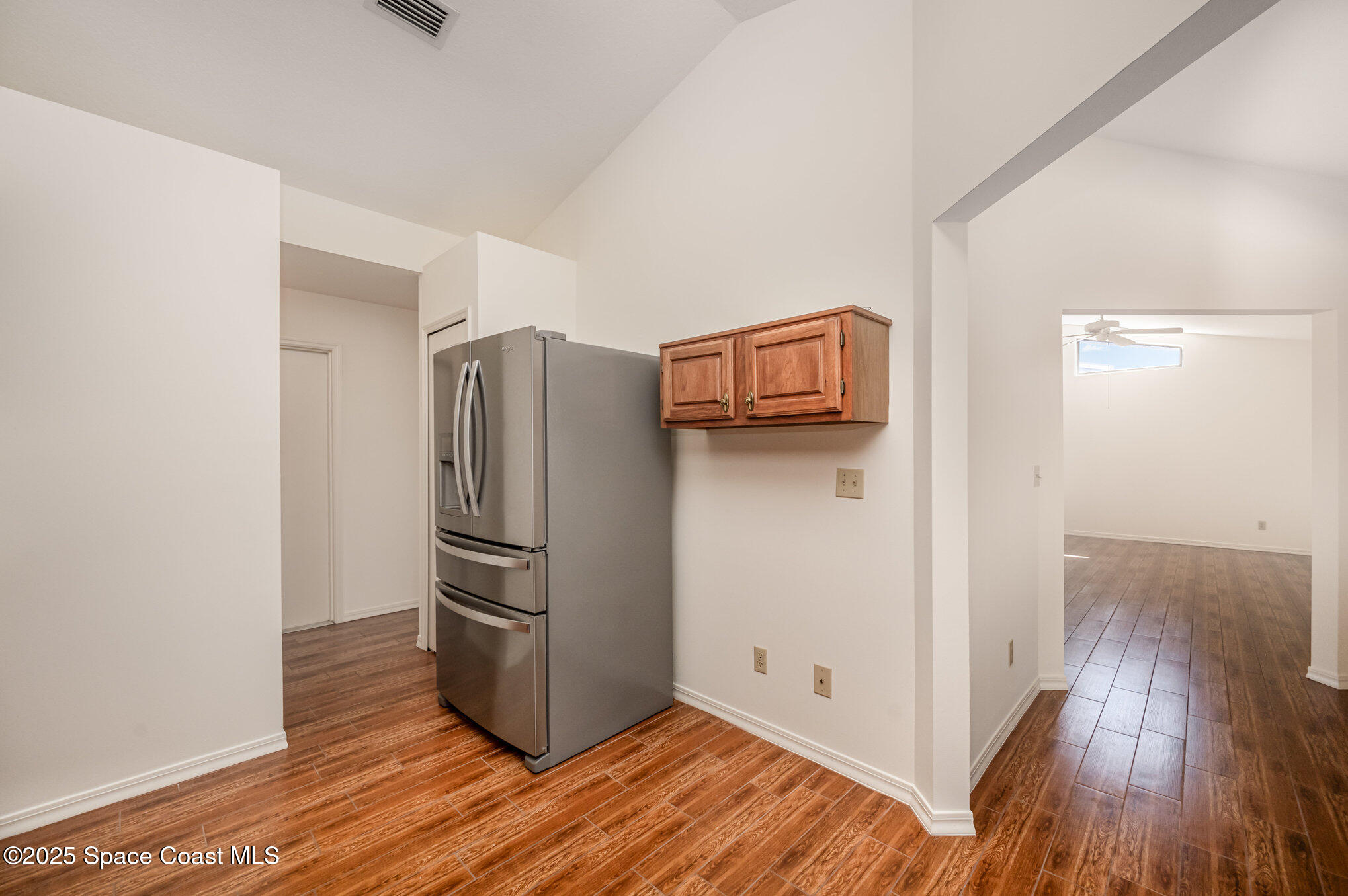 1652 Independence Avenue Melbourne, FL 32940 - Photo 11 of 38 a kitchen with a refrigerator and wooden floor