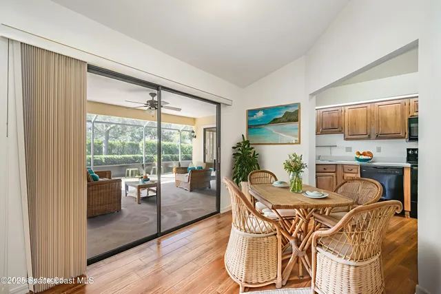 a dining room with furniture water view and wooden floor