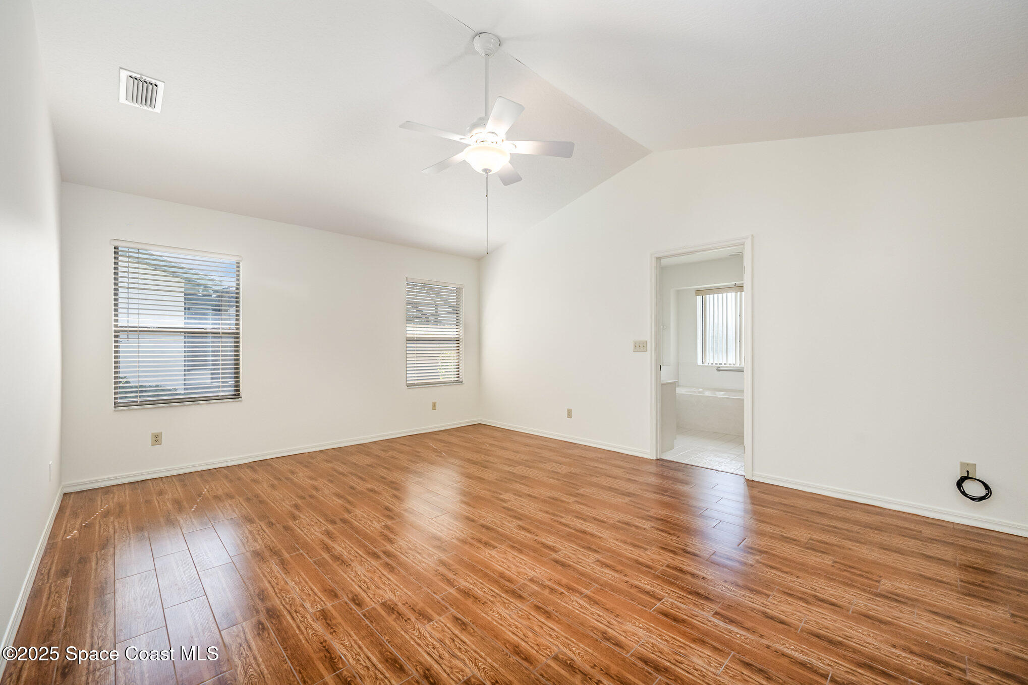 1652 Independence Avenue Melbourne, FL 32940 - Photo 15 of 38 a view of an empty room with wooden floor and a window