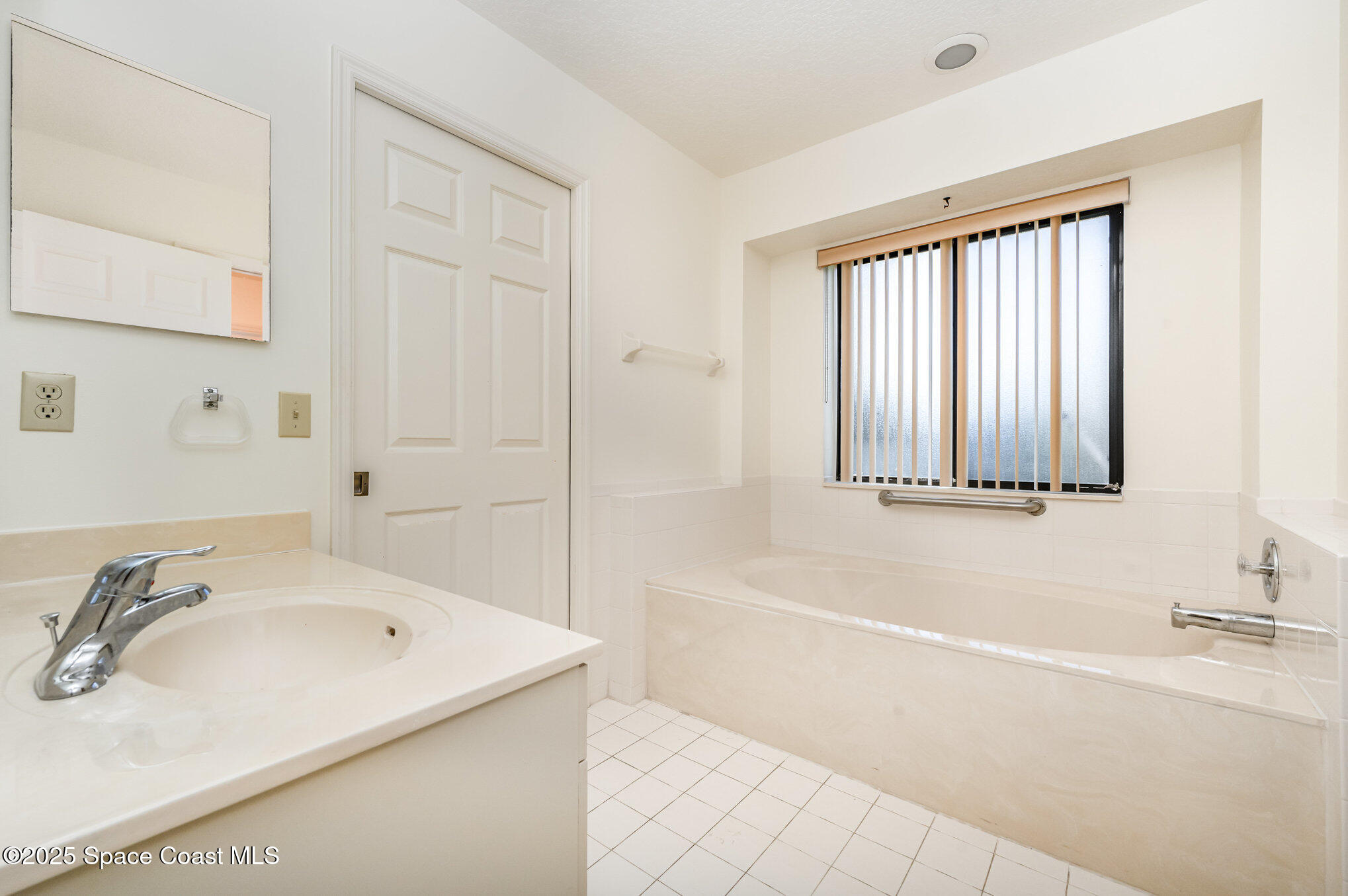 1652 Independence Avenue Melbourne, FL 32940 - Photo 17 of 38 a bathroom with a tub sink and a window