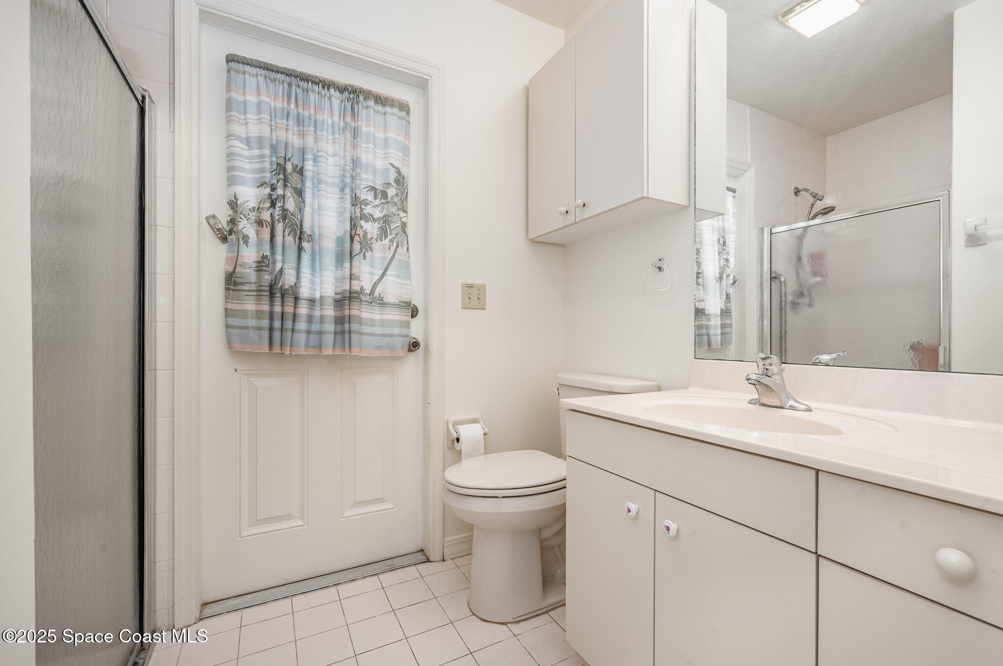 1652 Independence Avenue Melbourne, FL 32940 - Photo 18 of 38 a bathroom with a granite countertop sink a toilet and a mirror