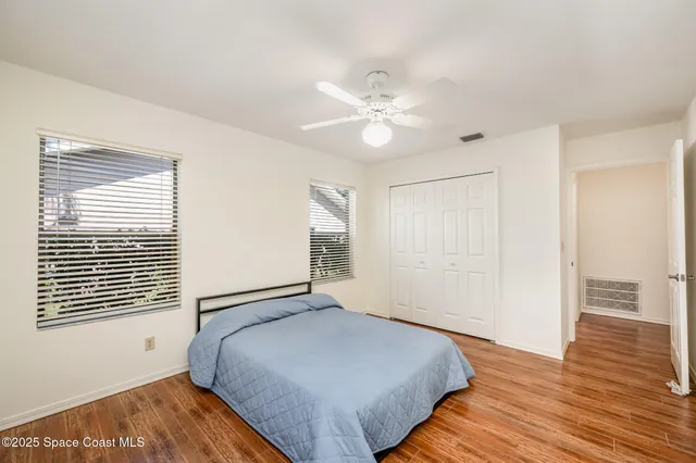 a view of a room with wooden floor and fan
