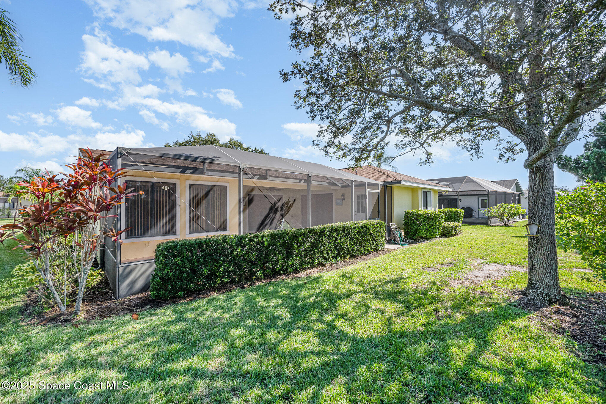 1652 Independence Avenue Melbourne, FL 32940 - Photo 26 of 38 a view of a white house with a big yard and large tree