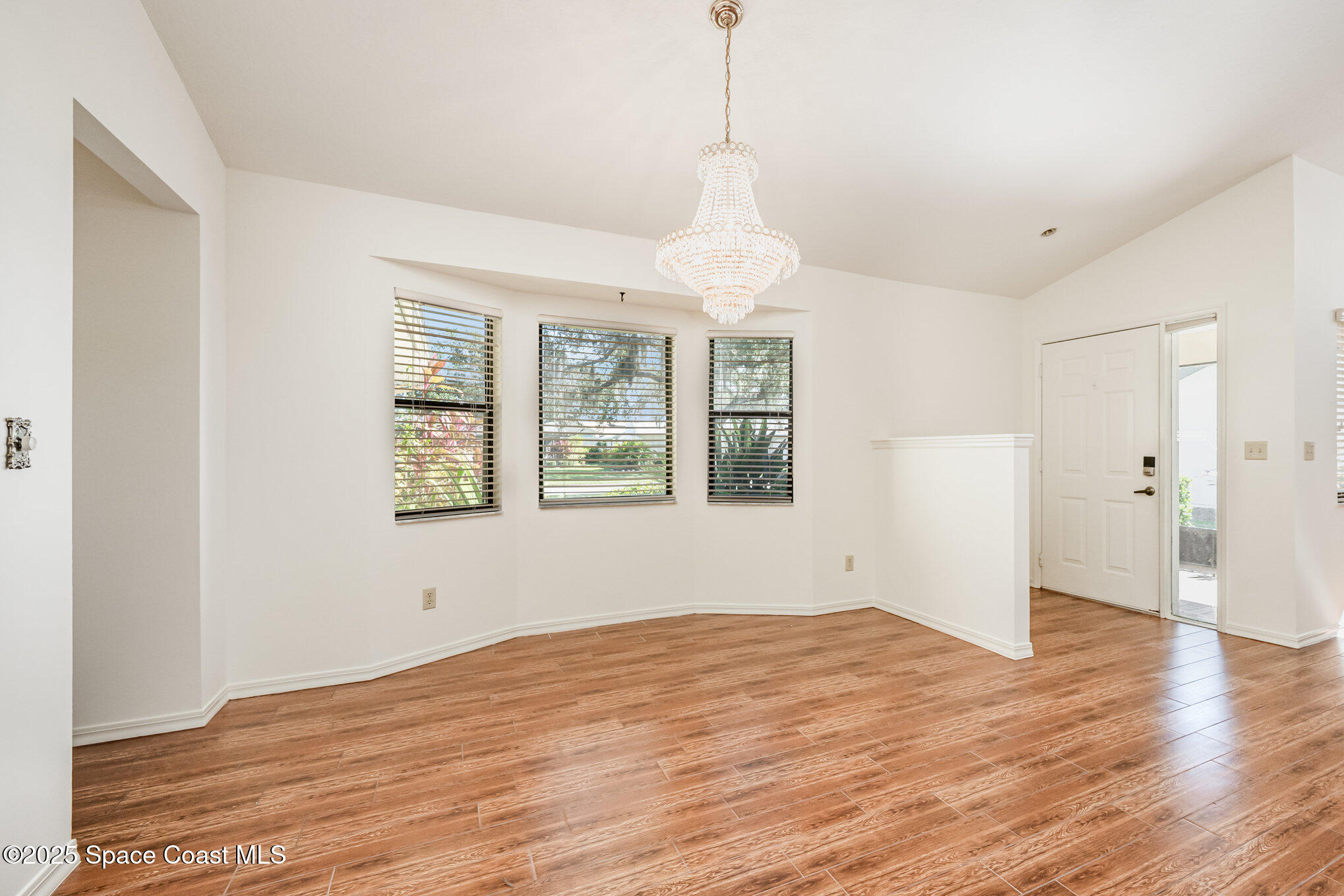 1652 Independence Avenue Melbourne, FL 32940 - Photo 5 of 38 a view of empty room with wooden floor and window