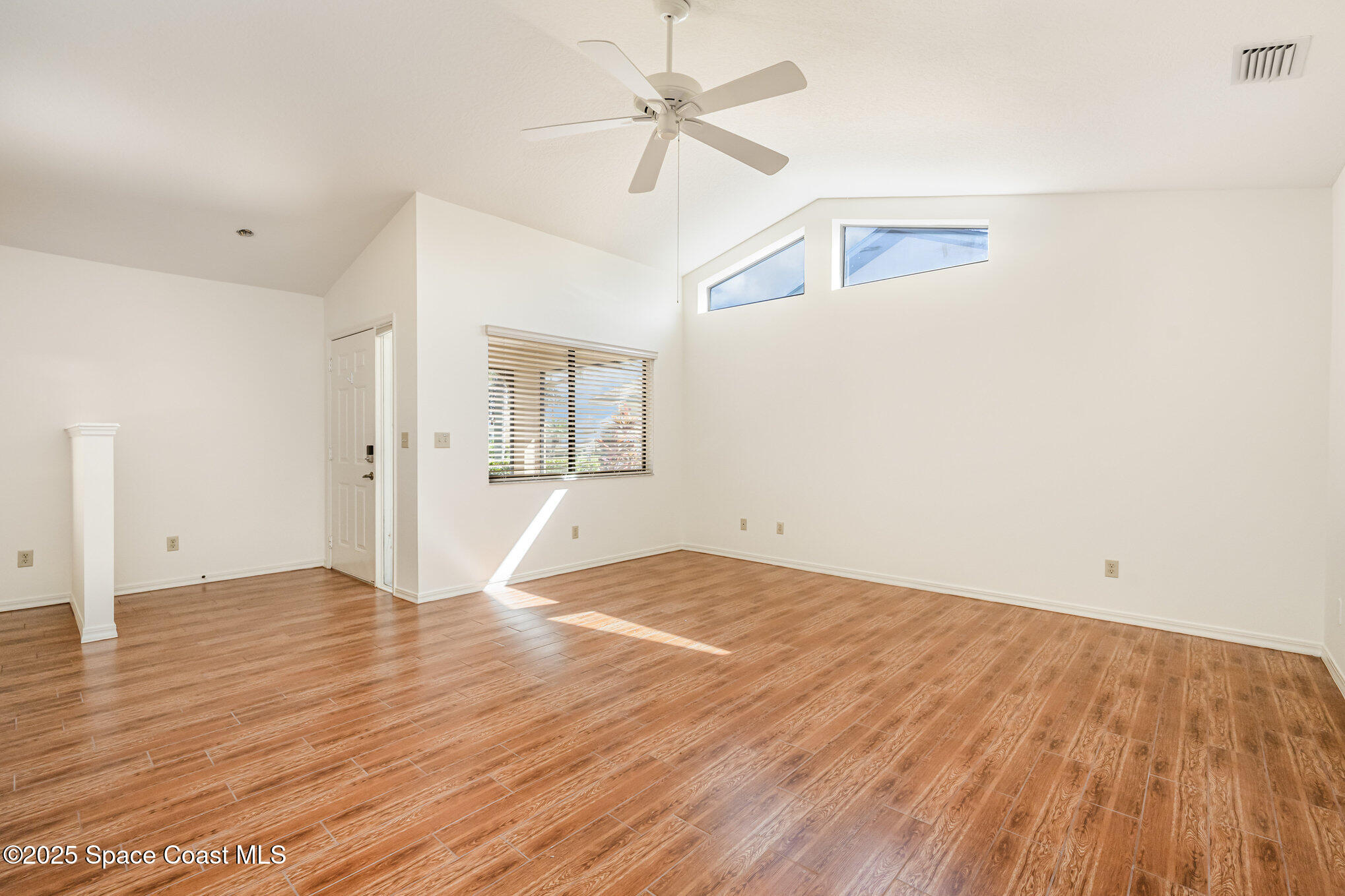 1652 Independence Avenue Melbourne, FL 32940 - Photo 7 of 38 an empty room with wooden floor and windows