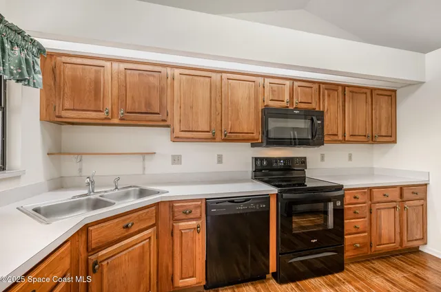 a kitchen with stainless steel appliances granite countertop a sink stove and microwave
