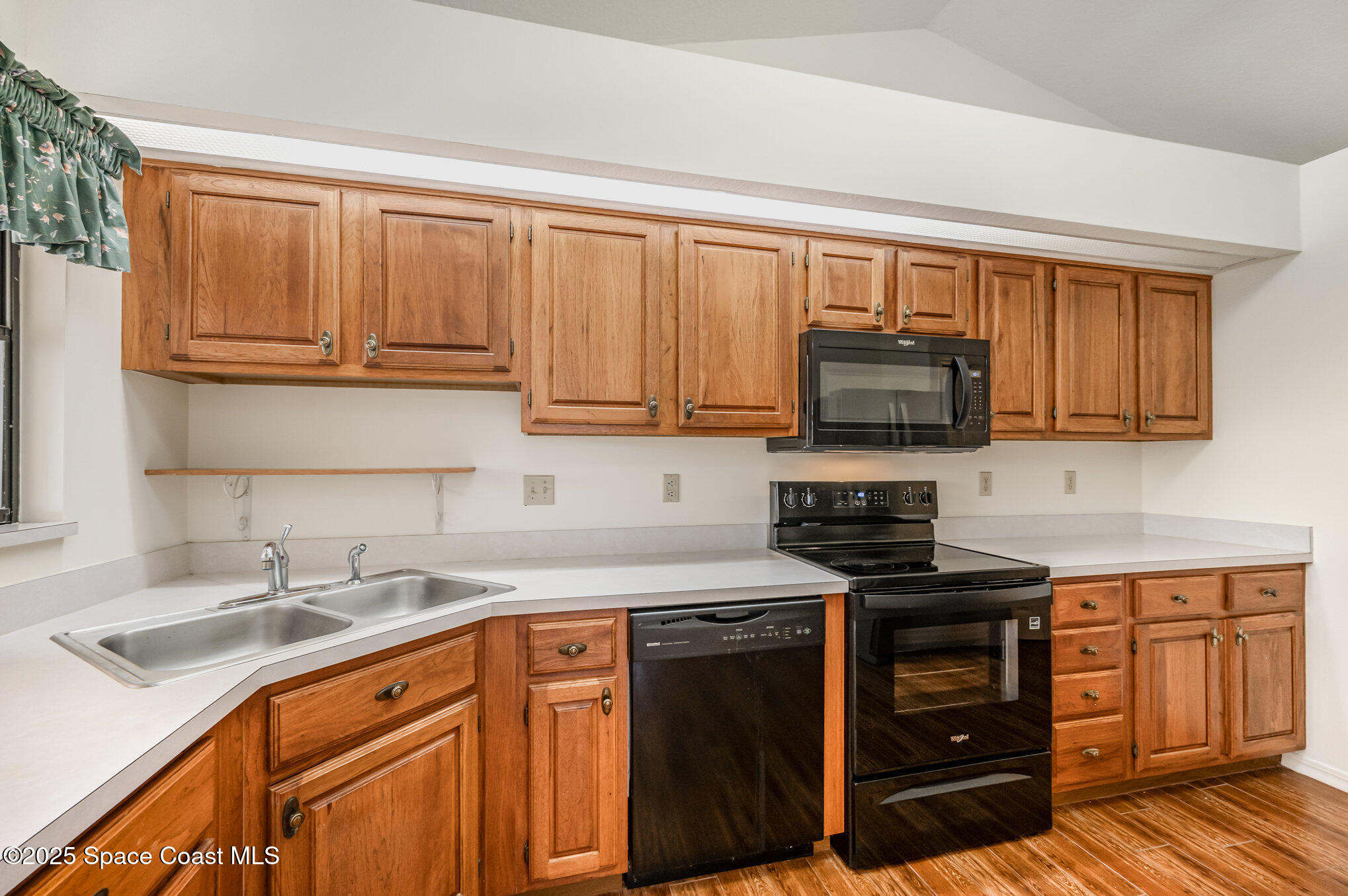 1652 Independence Avenue Melbourne, FL 32940 - Photo 9 of 38 a kitchen with stainless steel appliances granite countertop a sink stove and microwave