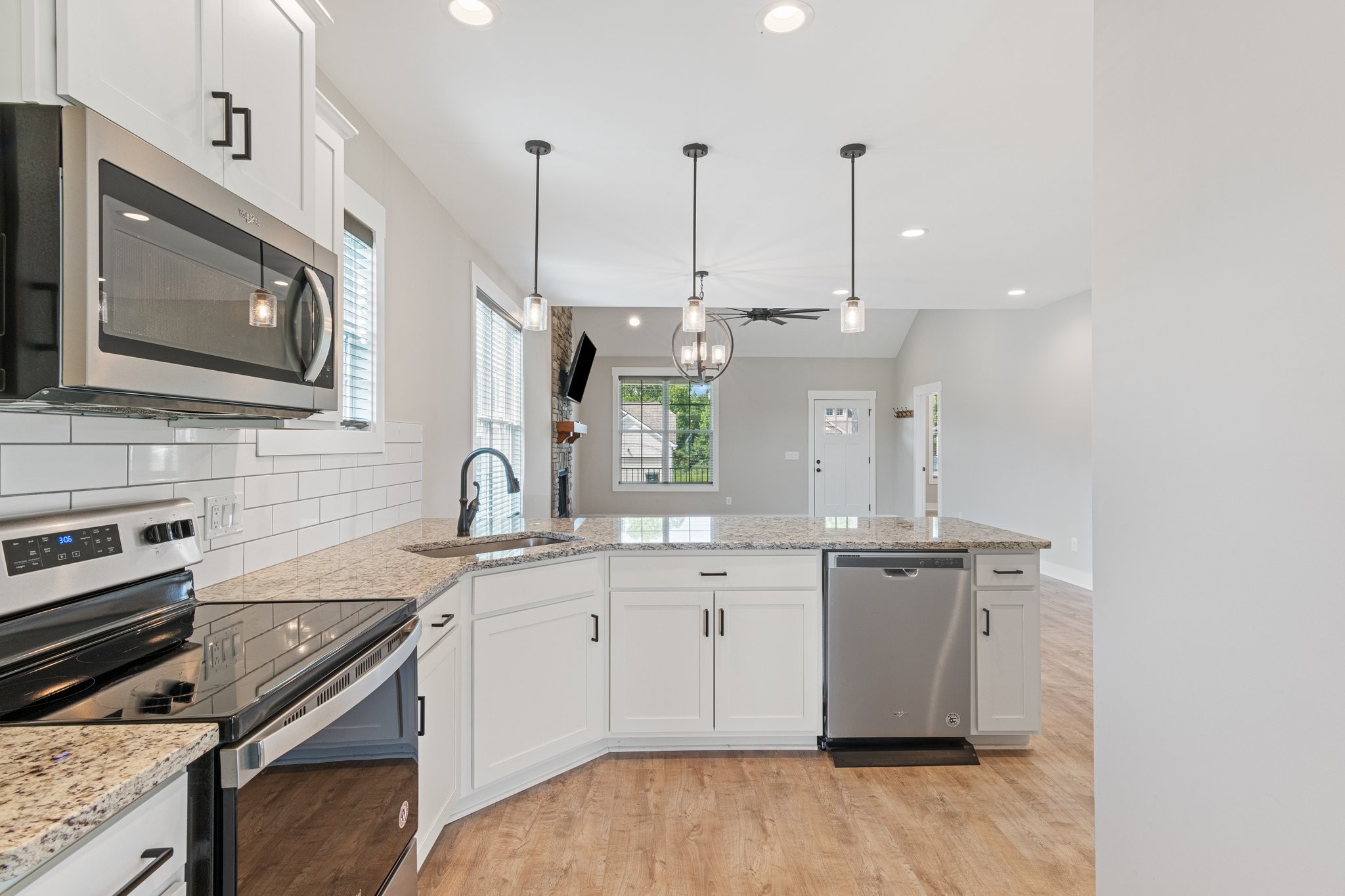 222 Julia Ann Court Springfield, TN 37172 - Photo 12 of 16 a kitchen with stainless steel appliances granite countertop a sink a stove and a microwave