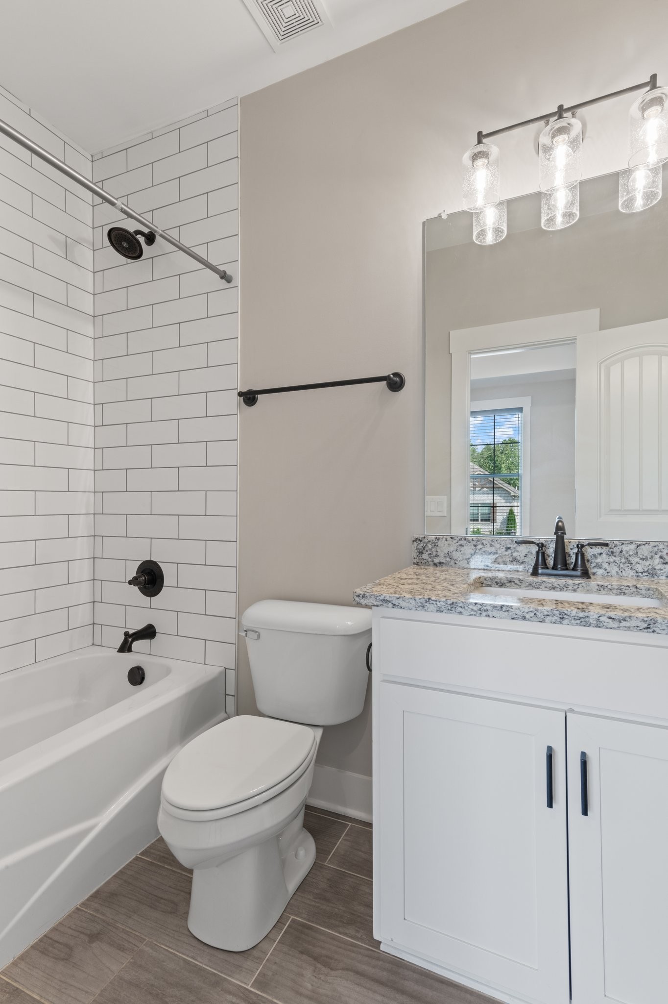 222 Julia Ann Court Springfield, TN 37172 - Photo 7 of 16 a bathroom with a granite countertop toilet a sink and a bathtub