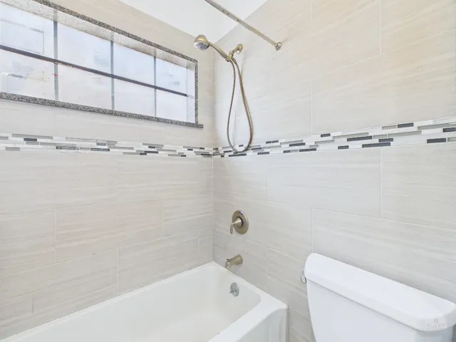 a bathroom with a shower a toilet and sink