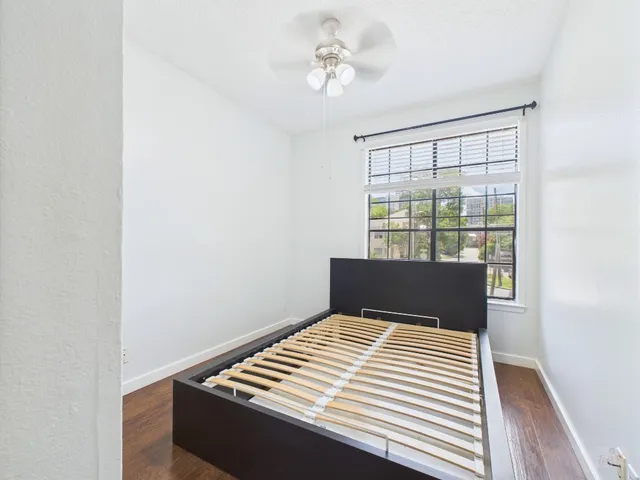 a view of a bedroom with wooden floor