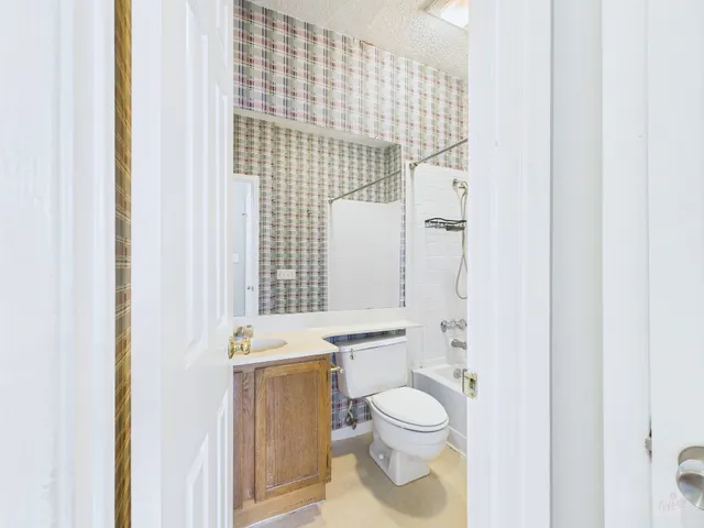 a bathroom with a toilet a sink and shower