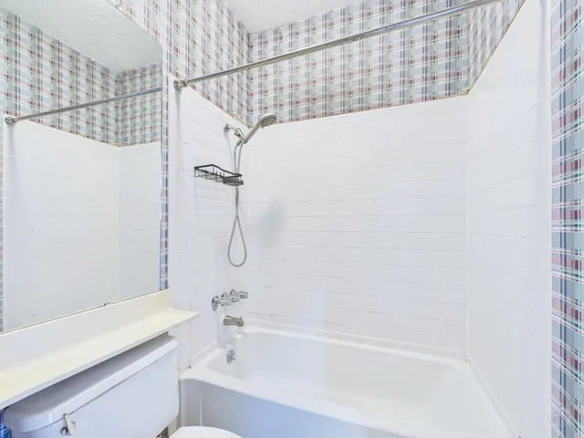 a bathroom with a bathtub and shower