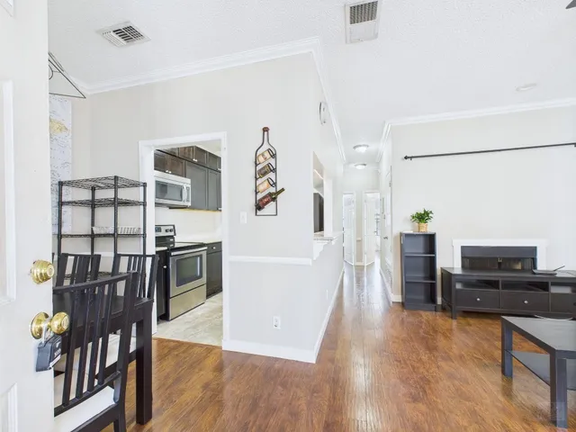 a living room with furniture and wooden floor