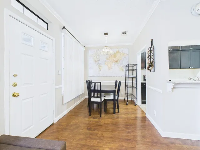 a view of a dining room with furniture and wooden floor