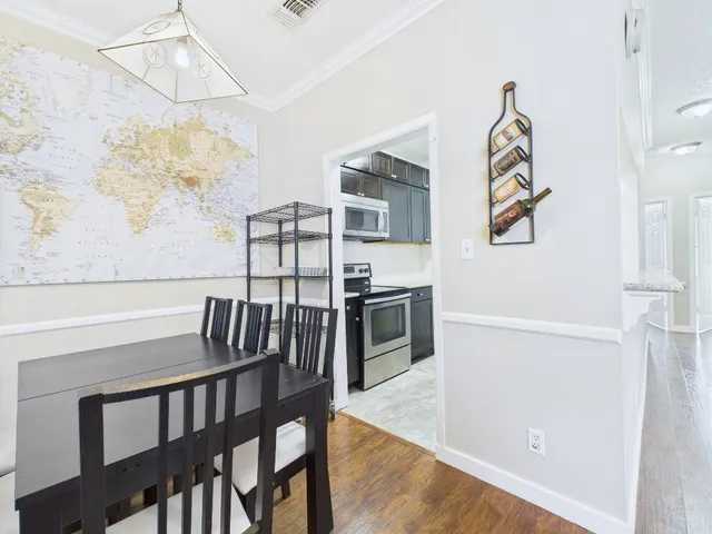 a view of a dining room with furniture and wooden floor