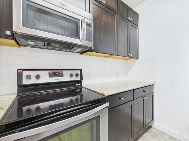 a stove top oven sitting inside of a kitchen