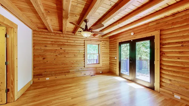 a view of a balcony with chairs and wooden floor