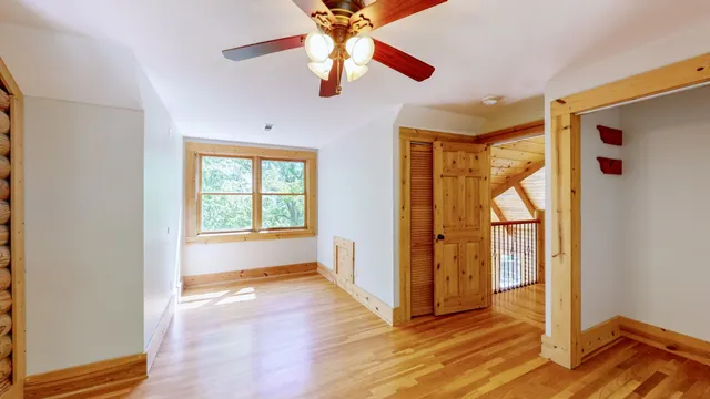 a big room with wooden floor and windows