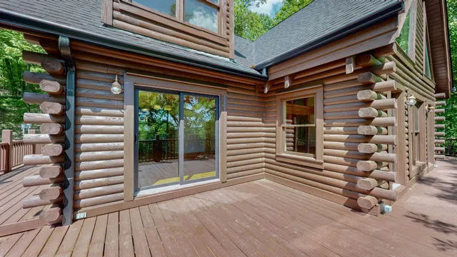 a view of a porch with wooden floor and fence