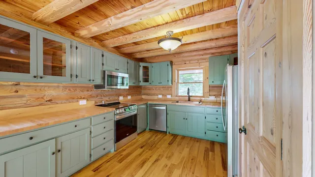 a kitchen with wooden cabinets and a stove top oven