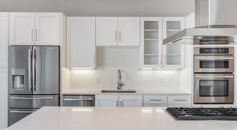 2728 Cedar Springs Road, Unit 1801 Dallas, TX 75201 - Photo 4 of 26 a kitchen with stainless steel appliances kitchen island granite countertop a stove and a refrigerator
