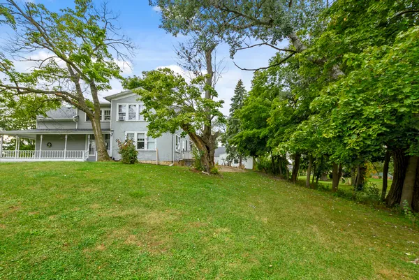 a backyard of a house with lots of green space and fountain