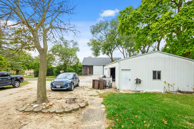 a view of a white house in the back yard