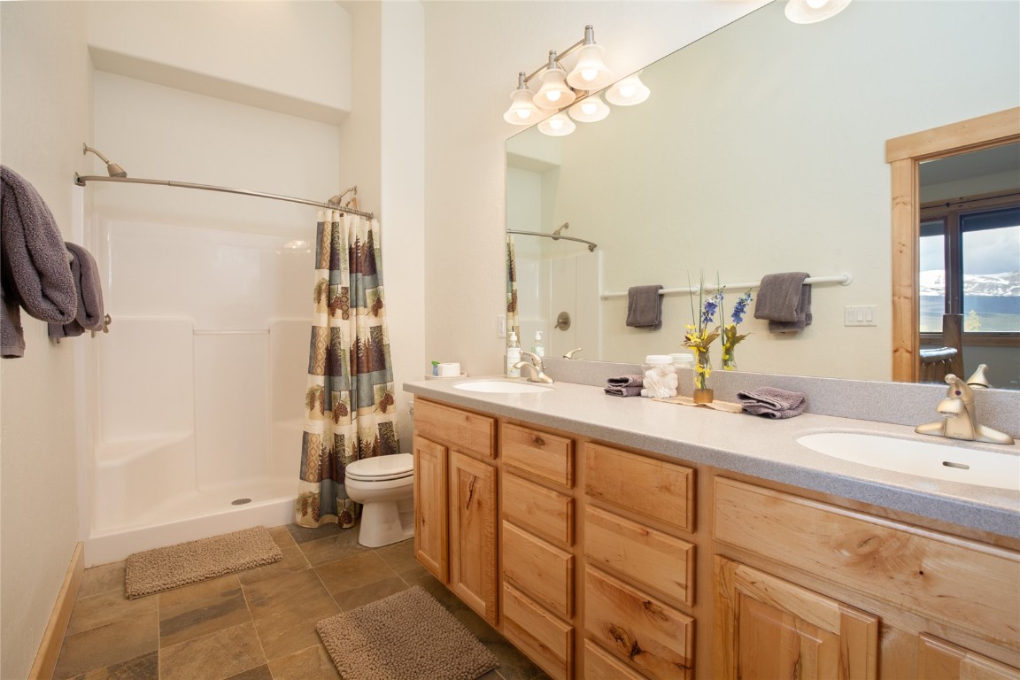 301 Polaris Road Fairplay, CO 80440 - Photo 16 of 35 a bathroom with a double vanity sink toilet and shower