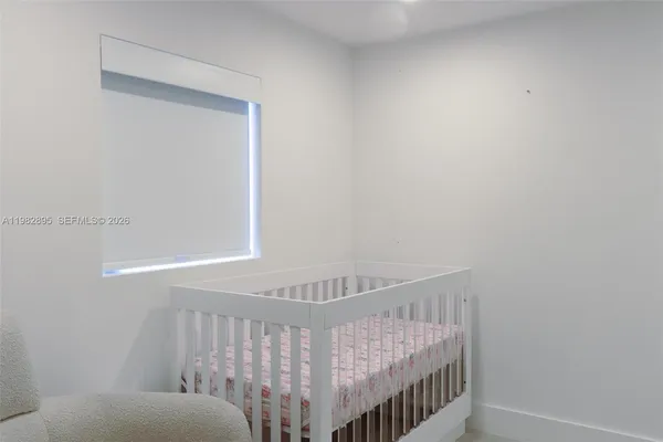 a living room with furniture potted plant and a ceiling fan