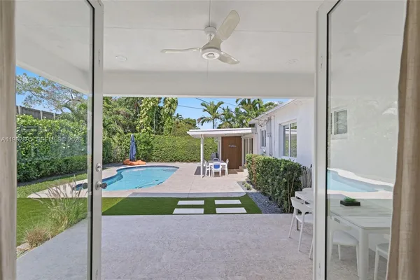 a view of a house with swimming pool and sitting area