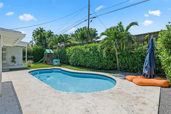 an aerial view of a house with outdoor space pool seating area and yard