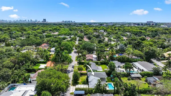 an aerial view of multiple houses with a yard