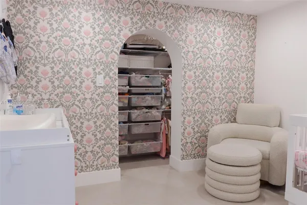 a bedroom with a bed and a white cabinet