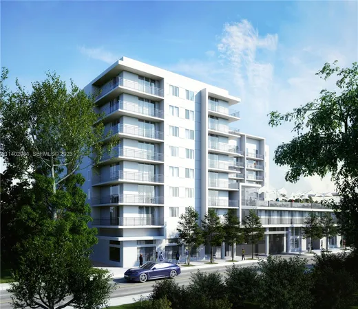 a front view of a building with a garden and plants