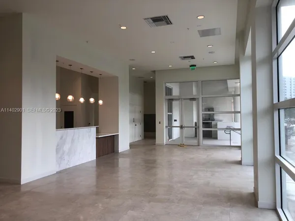 a view of a living room and a book shelf