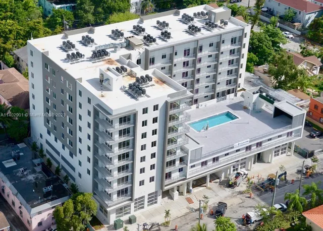 a tall building with large trees