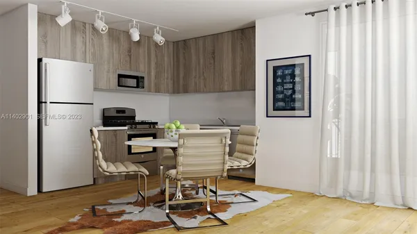 a kitchen with stainless steel appliances granite countertop a refrigerator stove a sink and dishwasher with wooden floor