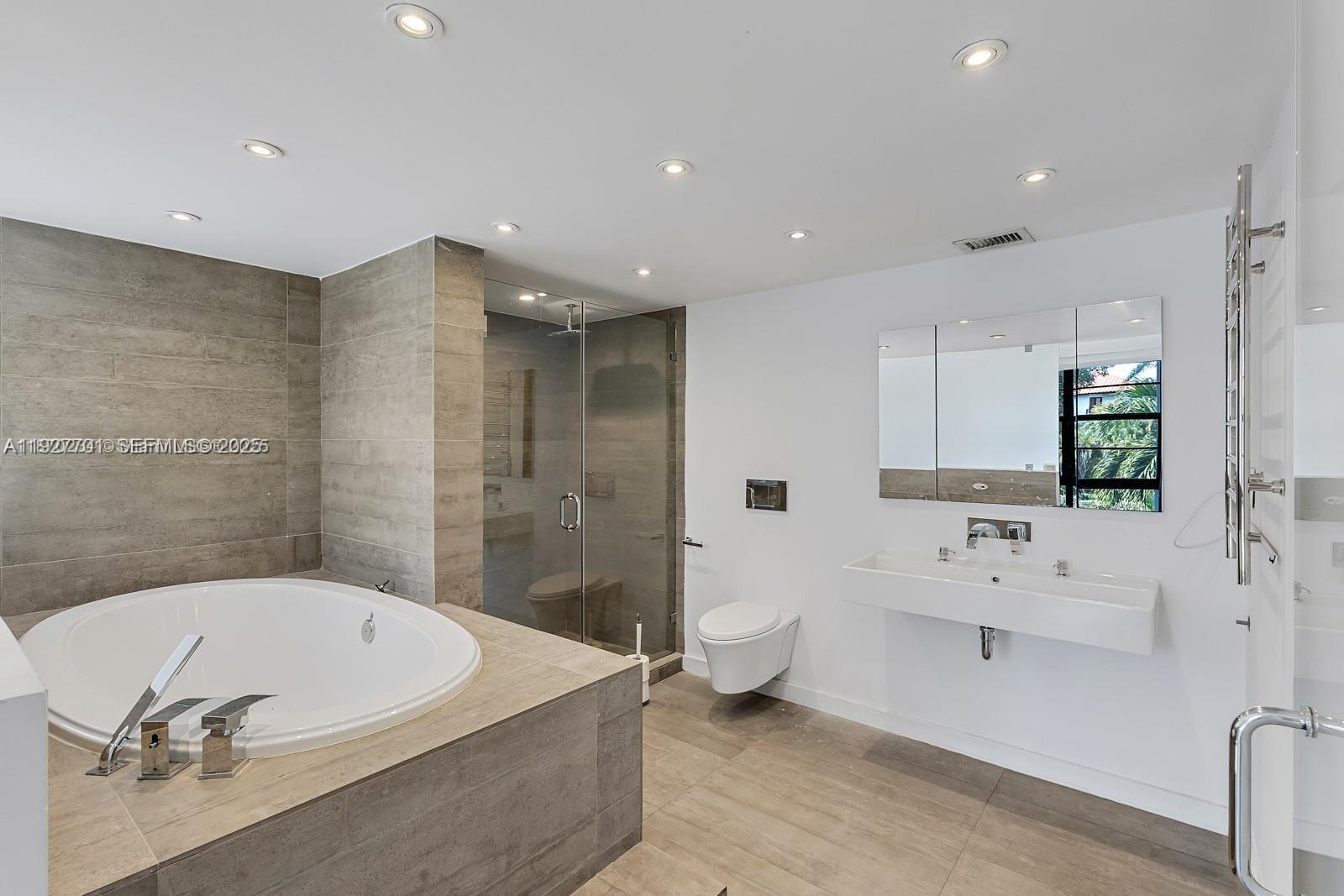 100 Ocean Ln Drive, Unit 304 Key Biscayne, FL 33149 - Photo 19 of 28 a bathroom with a bathtub and a toilet