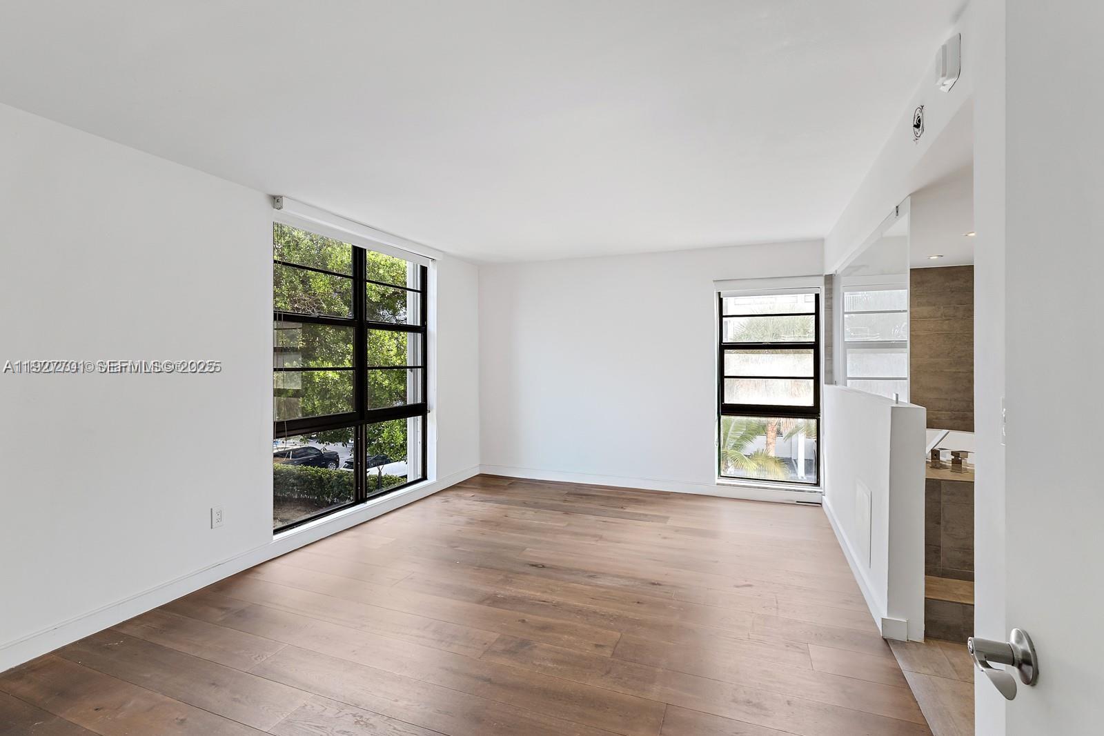 100 Ocean Ln Drive, Unit 304 Key Biscayne, FL 33149 - Photo 2 of 28 wooden floor in an empty room with a window