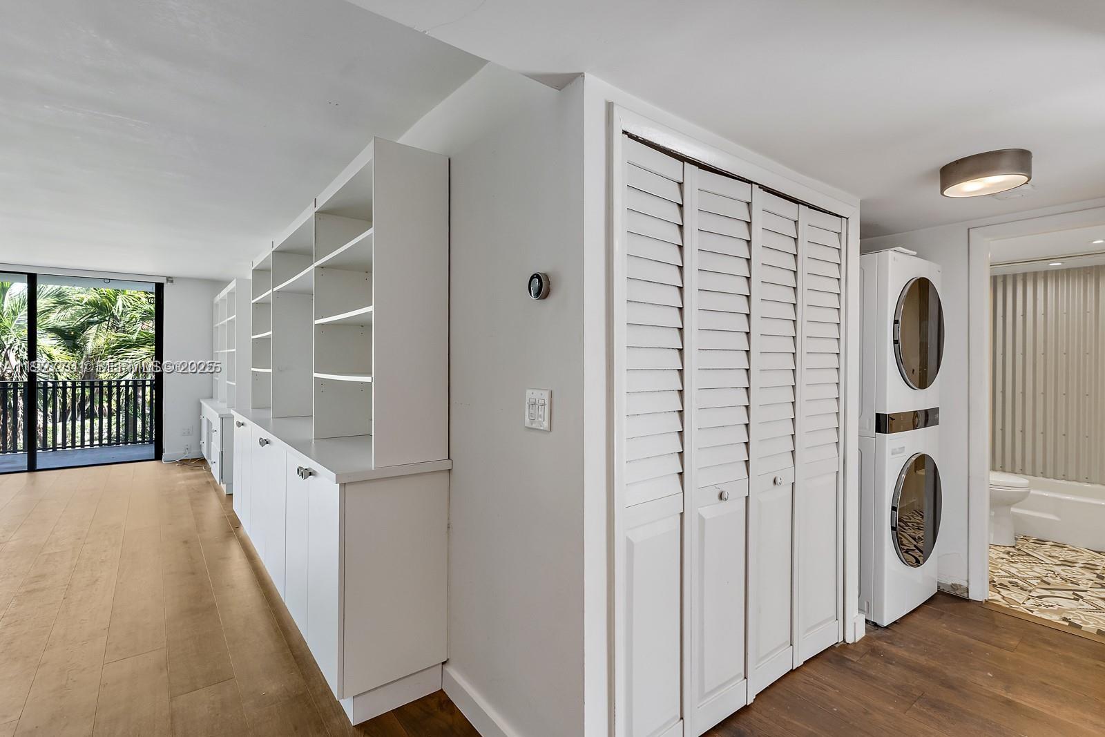 100 Ocean Ln Drive, Unit 304 Key Biscayne, FL 33149 - Photo 22 of 28 a view of a hallway with washer and dryer