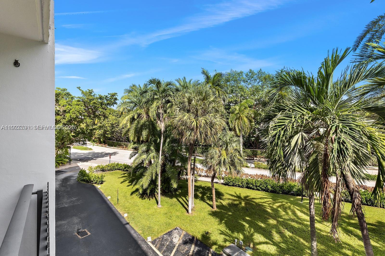 100 Ocean Ln Drive, Unit 304 Key Biscayne, FL 33149 - Photo 25 of 28 a view of a yard with an outdoor space