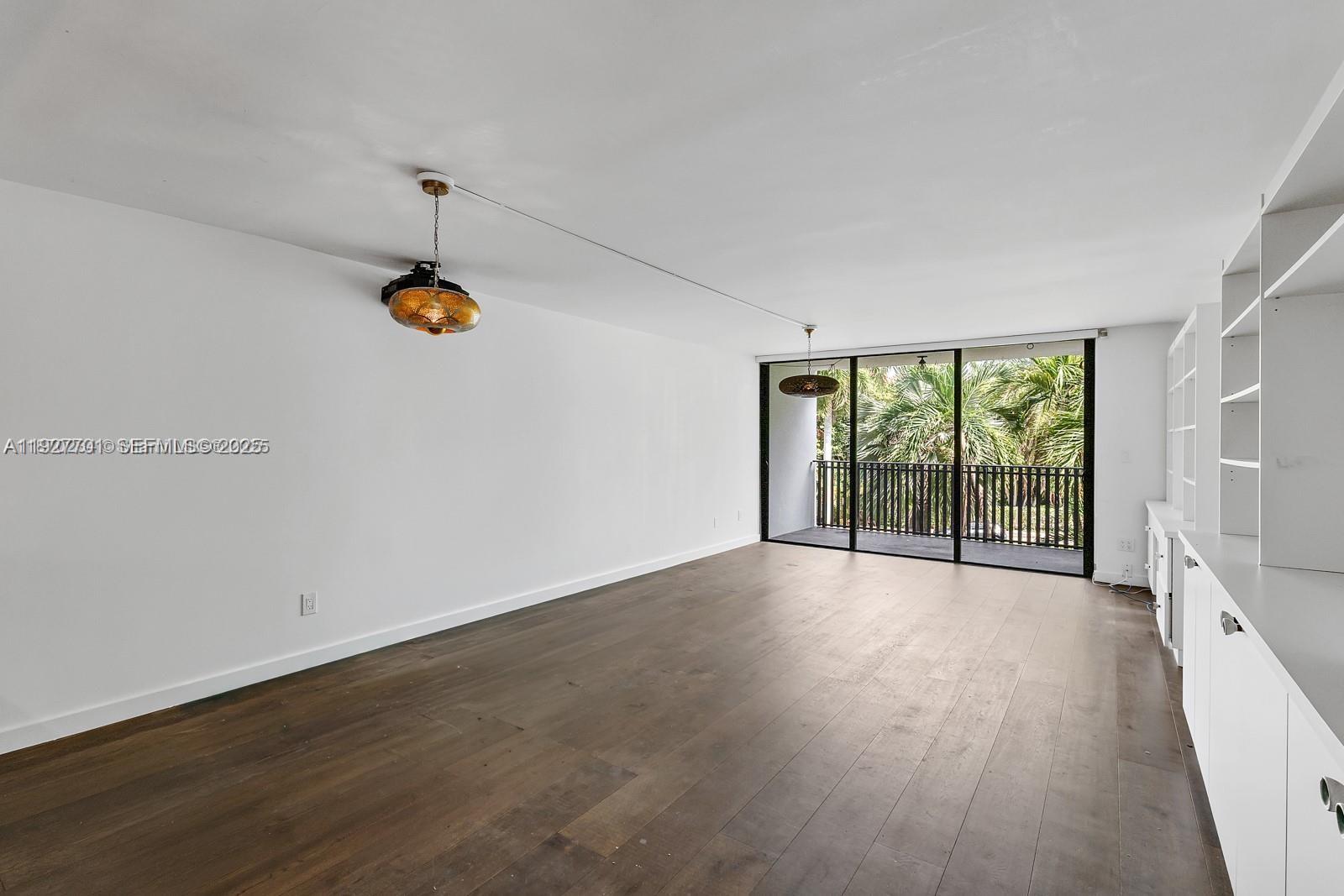 100 Ocean Ln Drive, Unit 304 Key Biscayne, FL 33149 - Photo 4 of 28 a view of an empty room with a window and wooden floor