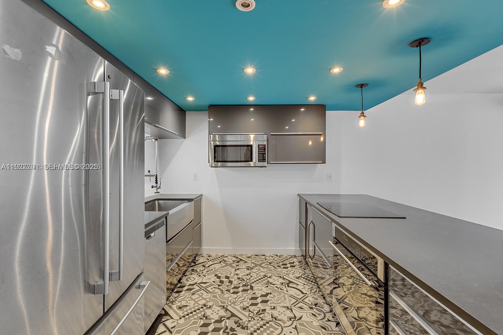 100 Ocean Ln Drive, Unit 304 Key Biscayne, FL 33149 - Photo 5 of 28 a kitchen with stainless steel appliances granite countertop a refrigerator and a sink