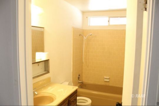 240 South Forest Knoll Street Ridgecrest, CA 93555 - Photo 9 of 23 a bathroom with a tub and shower