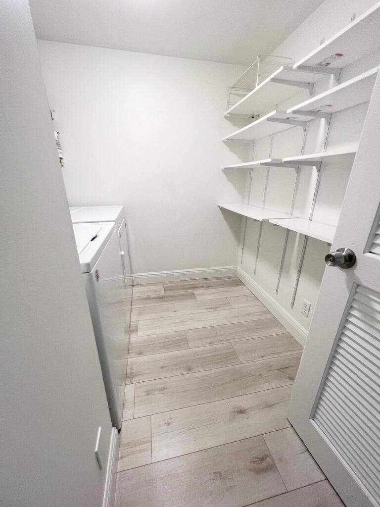 1006 Green Pine Boulevard, Unit A1 West Palm Beach, FL 33409 - Photo 13 of 25 a view of walk in closet with empty racks