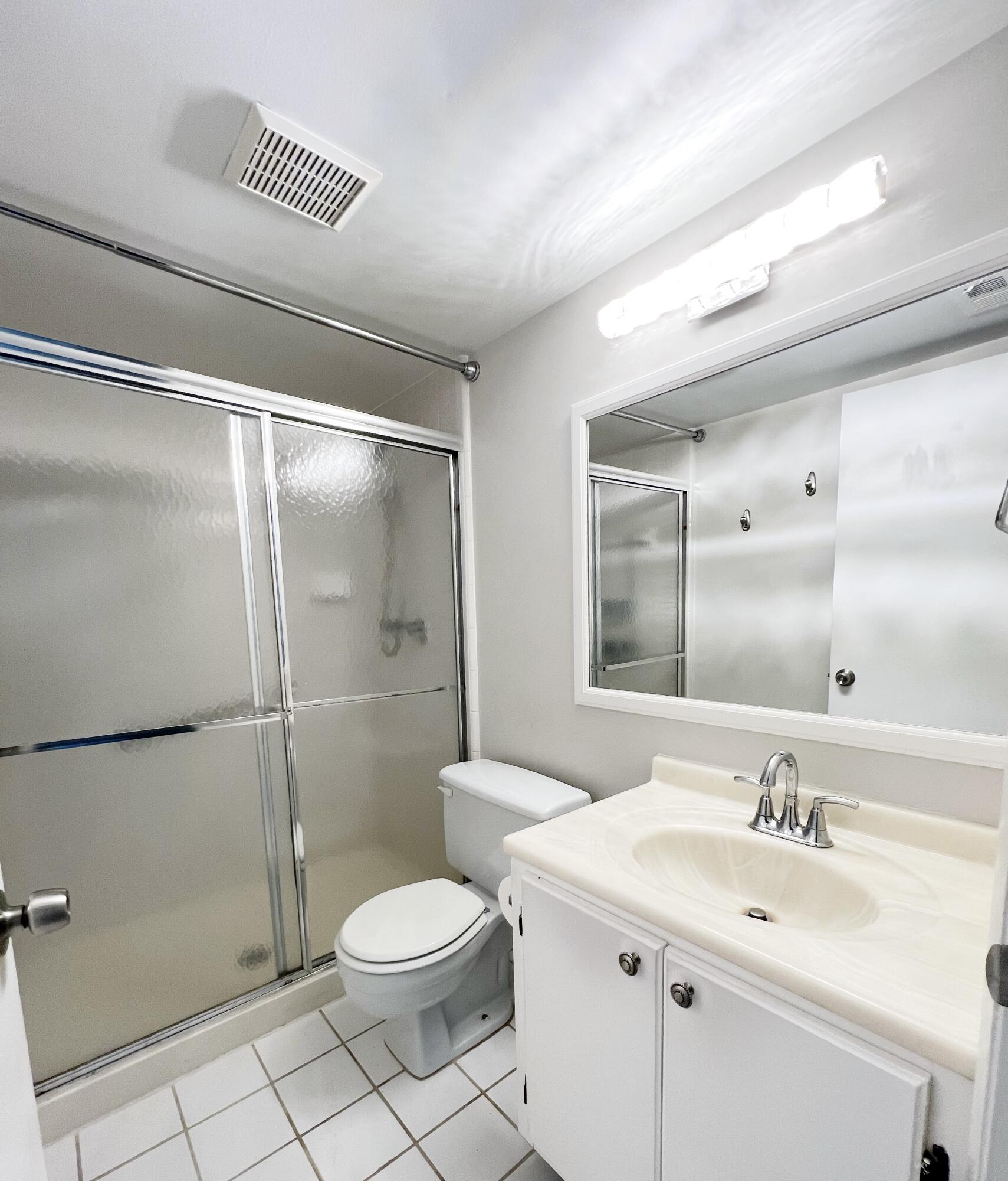 1006 Green Pine Boulevard, Unit A1 West Palm Beach, FL 33409 - Photo 15 of 25 a bathroom with a sink toilet and shower