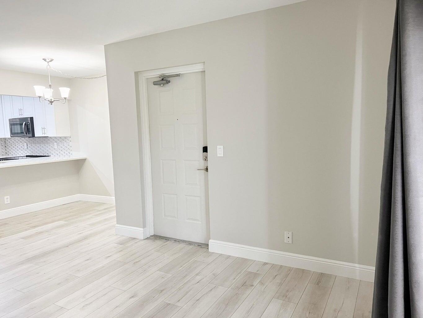 1006 Green Pine Boulevard, Unit A1 West Palm Beach, FL 33409 - Photo 16 of 25 a view of a hallway with wooden floor and a sink