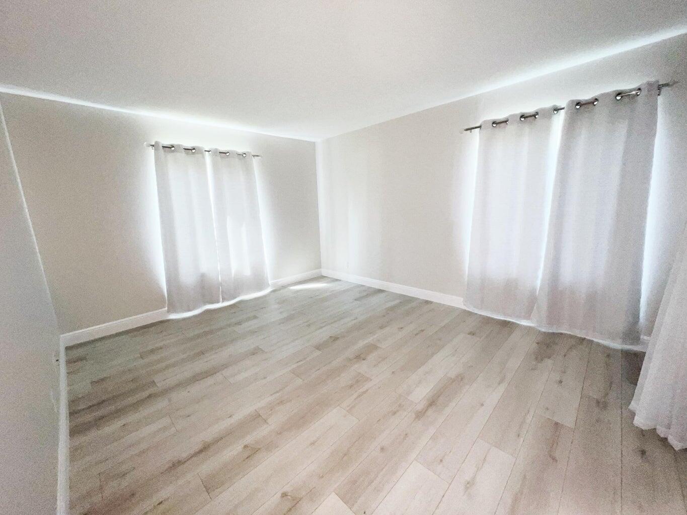 1006 Green Pine Boulevard, Unit A1 West Palm Beach, FL 33409 - Photo 17 of 25 wooden floor in an empty room