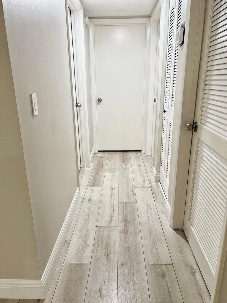 1006 Green Pine Boulevard, Unit A1 West Palm Beach, FL 33409 - Photo 20 of 25 a view of a hallway with wooden floor and staircase